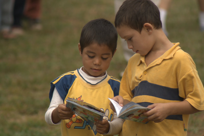 Boys reading a booklet